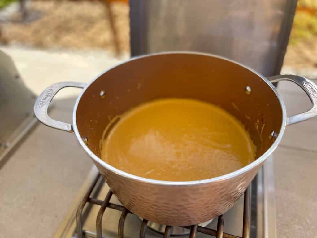 pumpkin spice cream in a copper heavy duty pot on a burner