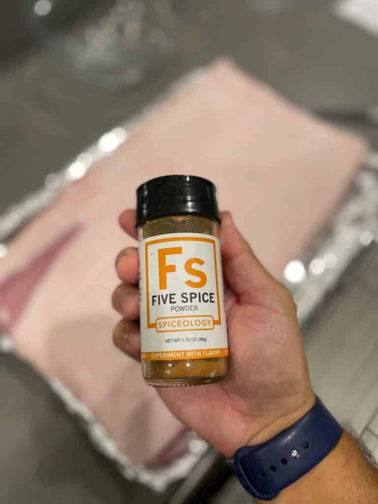Chef Anthony holding a bottle of spiceology five spice powder
