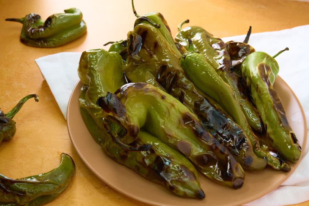 Charred Hatch Chiles on a terra cotta plate