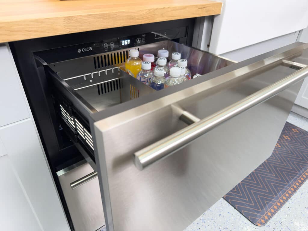 Elica Riserva Double Drawer Undercounted Refrigerator with the top drawer open inside Chef Anthony's Kitchen